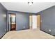 Bedroom featuring neutral carpet, gray walls, and doorways to other rooms at 5146 Elementary View Dr, Charlotte, NC 28269