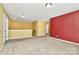 Open bonus room with carpet flooring and neutral walls and one red accent wall at 5146 Elementary View Dr, Charlotte, NC 28269