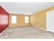 Open bonus room with carpet flooring, neutral and red accent walls at 5146 Elementary View Dr, Charlotte, NC 28269