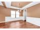 Elegant dining area featuring wood floors, wainscoting, and a stylish chandelier creating an inviting atmosphere at 5146 Elementary View Dr, Charlotte, NC 28269