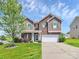 Charming two-story home featuring brick and wood accents, complemented by a well-manicured lawn and a two-car garage at 5146 Elementary View Dr, Charlotte, NC 28269