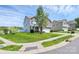Corner lot home showcasing a well-maintained lawn, mature tree, and a mix of brick and wood exterior at 5146 Elementary View Dr, Charlotte, NC 28269