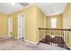 Bright hallway with neutral carpet and yellow walls leading to the upper level at 5146 Elementary View Dr, Charlotte, NC 28269