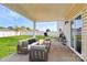 Staged patio with outdoor furniture including a couch and chairs with plush lawn view at 5146 Elementary View Dr, Charlotte, NC 28269