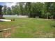 Expansive backyard featuring a manicured lawn, mature trees, and a full perimeter privacy fence at 5817 Wingate Hill Rd, Denver, NC 28037