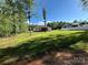 Beautiful backyard with mature trees and a white privacy fence at 5817 Wingate Hill Rd, Denver, NC 28037