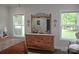 Bright bedroom with natural light, wooden dresser, and serene window views at 5817 Wingate Hill Rd, Denver, NC 28037
