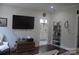 Comfortable bedroom features an entertainment center and adjacent bathroom at 5817 Wingate Hill Rd, Denver, NC 28037