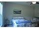 Relaxing bedroom with a queen-sized bed, soft blue accents, and a comfortable seating area at 5817 Wingate Hill Rd, Denver, NC 28037