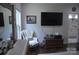 Comfortable bedroom with an accent chair, dresser, and entertainment center at 5817 Wingate Hill Rd, Denver, NC 28037