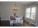Bright dining room featuring a window and elegant chandelier at 5817 Wingate Hill Rd, Denver, NC 28037