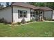 Beautifully landscaped front yard with colorful flower beds and a well-manicured lawn enhances the home's curb appeal at 5817 Wingate Hill Rd, Denver, NC 28037
