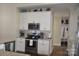 Well-lit kitchen features white cabinets, stainless steel appliances, and granite countertops at 5817 Wingate Hill Rd, Denver, NC 28037