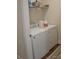 Functional laundry room features a white washer, dryer, and shelving at 5817 Wingate Hill Rd, Denver, NC 28037