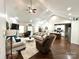 Spacious living room with vaulted ceilings, fireplace, and a view into the kitchen and dining area at 5817 Wingate Hill Rd, Denver, NC 28037