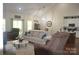 Open living room features hardwood floors, comfortable seating, access to deck and kitchen at 5817 Wingate Hill Rd, Denver, NC 28037