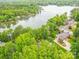 Scenic aerial view of the house surrounded by lush greenery and serene lake, with the boat dock in view at 5951 Johnson Rd, Clover, SC 29710
