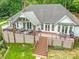 Spacious back exterior with a large deck, hot tub, comfortable seating, and scenic backyard views at 5951 Johnson Rd, Clover, SC 29710