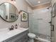 Bathroom featuring a gray vanity, marble countertop, round mirror, and a walk-in shower with glass door at 5951 Johnson Rd, Clover, SC 29710