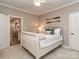 Neutral colored bedroom with white bed, oars for decor, and an doorway into the kitchen and living spaces at 5951 Johnson Rd, Clover, SC 29710