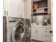Laundry room featuring a stainless steel washer and dryer, sink, and shelving with a basket at 5951 Johnson Rd, Clover, SC 29710