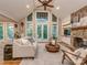 Sunlit living room featuring a stone fireplace, hardwood floors, and access to the outdoors at 5951 Johnson Rd, Clover, SC 29710