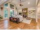 Bright living room with large windows, vaulted ceiling, stone fireplace, and hardwood floors at 5951 Johnson Rd, Clover, SC 29710