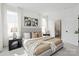 Well-lit bedroom with neutral tones, carpeted floors, a large bed, and ensuite bathroom at 6005 Countess Dr # 49, Charlotte, NC 28217