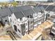 Modern townhome exteriors featuring a mix of white and gray siding with black trim at 6005 Countess Dr # 49, Charlotte, NC 28217