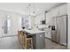 Bright kitchen with a center island, stylish seating, stainless steel appliances, and white cabinets at 6005 Countess Dr # 49, Charlotte, NC 28217