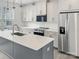 Bright kitchen featuring stainless steel appliances, a large island, and white cabinets at 6005 Countess Dr # 49, Charlotte, NC 28217