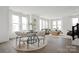 Bright and airy living and dining area with large windows, modern furniture, and hardwood floors at 6005 Countess Dr # 49, Charlotte, NC 28217