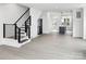 Open-concept living room with modern staircase and view of the kitchen at 6005 Countess Dr # 49, Charlotte, NC 28217