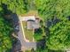 Aerial view of a home nestled among lush trees, showcasing its location and setting at 6338 Rosecrest Dr, Charlotte, NC 28210