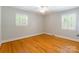 A large bedroom with hardwood flooring, natural light and a ceiling fan at 6338 Rosecrest Dr, Charlotte, NC 28210