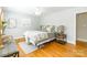 Comfortable bedroom with wood floors, ceiling fan, natural light, and neutral decor at 6338 Rosecrest Dr, Charlotte, NC 28210