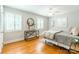 Light and bright bedroom with hardwood floors, ceiling fan, and plenty of natural light at 6338 Rosecrest Dr, Charlotte, NC 28210