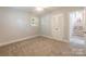 Neutral bedroom featuring a wall closet, neutral carpet and a sunny window with white shutters at 6338 Rosecrest Dr, Charlotte, NC 28210