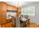 Cozy dining room with hardwood floors, built-in cabinets, and shuttered windows at 6338 Rosecrest Dr, Charlotte, NC 28210