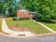 Corner lot featuring a well-maintained home, retaining wall, and healthy, green lawn at 6338 Rosecrest Dr, Charlotte, NC 28210