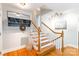 Inviting foyer with hardwood floors, coat rack and staircase at 6338 Rosecrest Dr, Charlotte, NC 28210