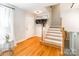Hardwood foyer featuring a staircase, coat rack, and access to lower level at 6338 Rosecrest Dr, Charlotte, NC 28210