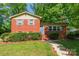 Charming brick home with manicured lawn and inviting blue front door at 6338 Rosecrest Dr, Charlotte, NC 28210