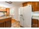 View of kitchen showing dining nook, refrigerator, wood cabinets and granite countertops at 6338 Rosecrest Dr, Charlotte, NC 28210