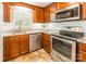 Close up of the kitchen with stainless steel appliances, granite counters, and wood cabinetry at 6338 Rosecrest Dr, Charlotte, NC 28210