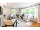 Sunlit living room with hardwood floors, large windows, and stylish furnishings at 6338 Rosecrest Dr, Charlotte, NC 28210