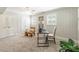 Sun-filled home office featuring a modern desk setup, neutral carpet, and patterned accent wall at 6338 Rosecrest Dr, Charlotte, NC 28210