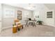 Bright office with a patterned accent wall, two windows with shutters, and stylish modern furniture at 6338 Rosecrest Dr, Charlotte, NC 28210