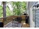 Spacious wooden deck with outdoor seating, and view of a tranquil, lush backyard at 703 S Main St, Landis, NC 28088