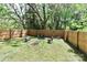 Large backyard featuring a fire pit area and seating, surrounded by a newly constructed privacy fence at 703 S Main St, Landis, NC 28088